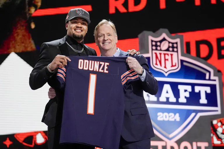Rome Odunze at NFL draft with commissioner Rodger Goodell. 9th overall