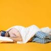 a man sleeps on his side against a yellow background sleep quality