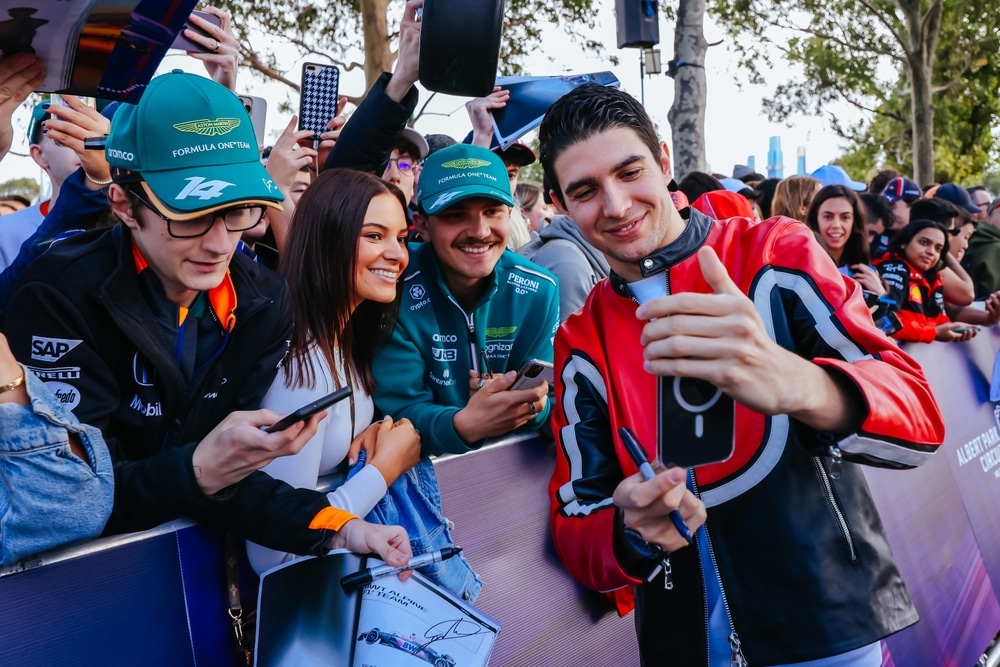 Esteban Ocon takes a selfie with fans.