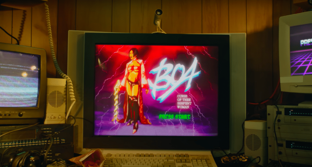 In the music video for "BOA," a cartoon version of Megan Thee Stallion is on an older computer. Next to her are the words "BOA Curse of the Serpent Woman Press Start" in the style of older video games.