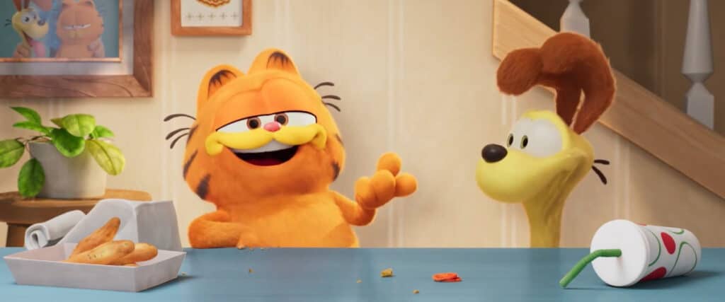 Garfield (Chris Pratt) and Odie (Gregg Berger) standing side by side with one another.