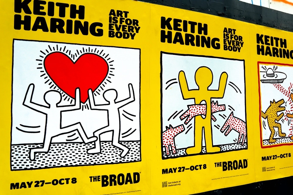 Advertisements for the Keith Haring: Art is for Everybody show at The Broad are plastered on a wall.