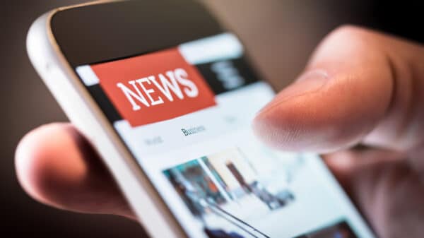 A close up of browsing online news on a mobile phone.
