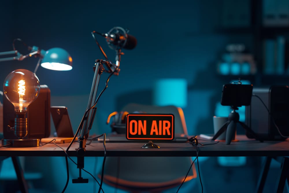 A picture of a desk with an "On Air" radio sign on top of it. 