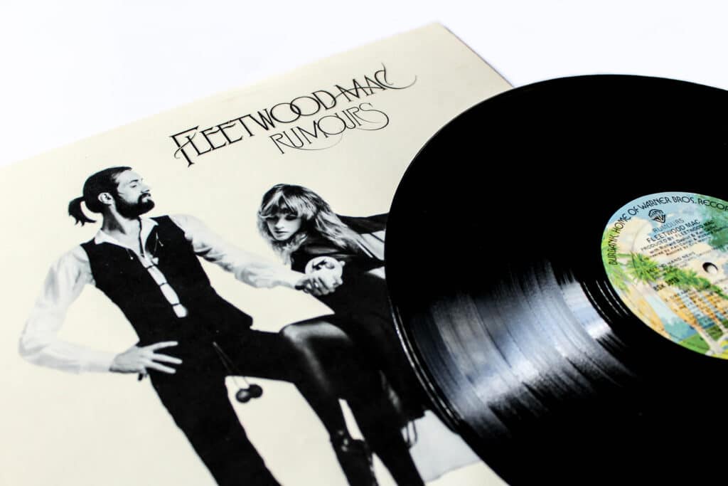 The album cover of Rumours by Fleetwood Mac is partially covered by a record.