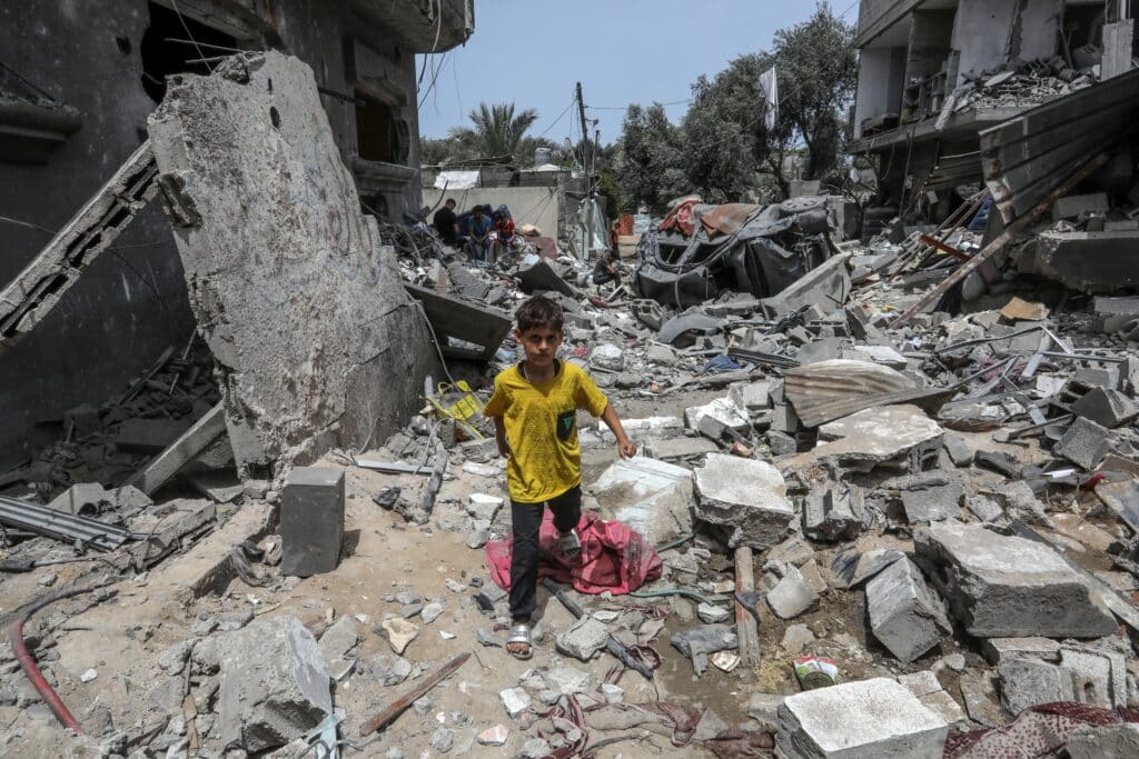 A Palestinian boy amongst the rubble of a home in Gaza, on May 19th, 2024. Credit: Shutterstock/Anas-Mohammed
